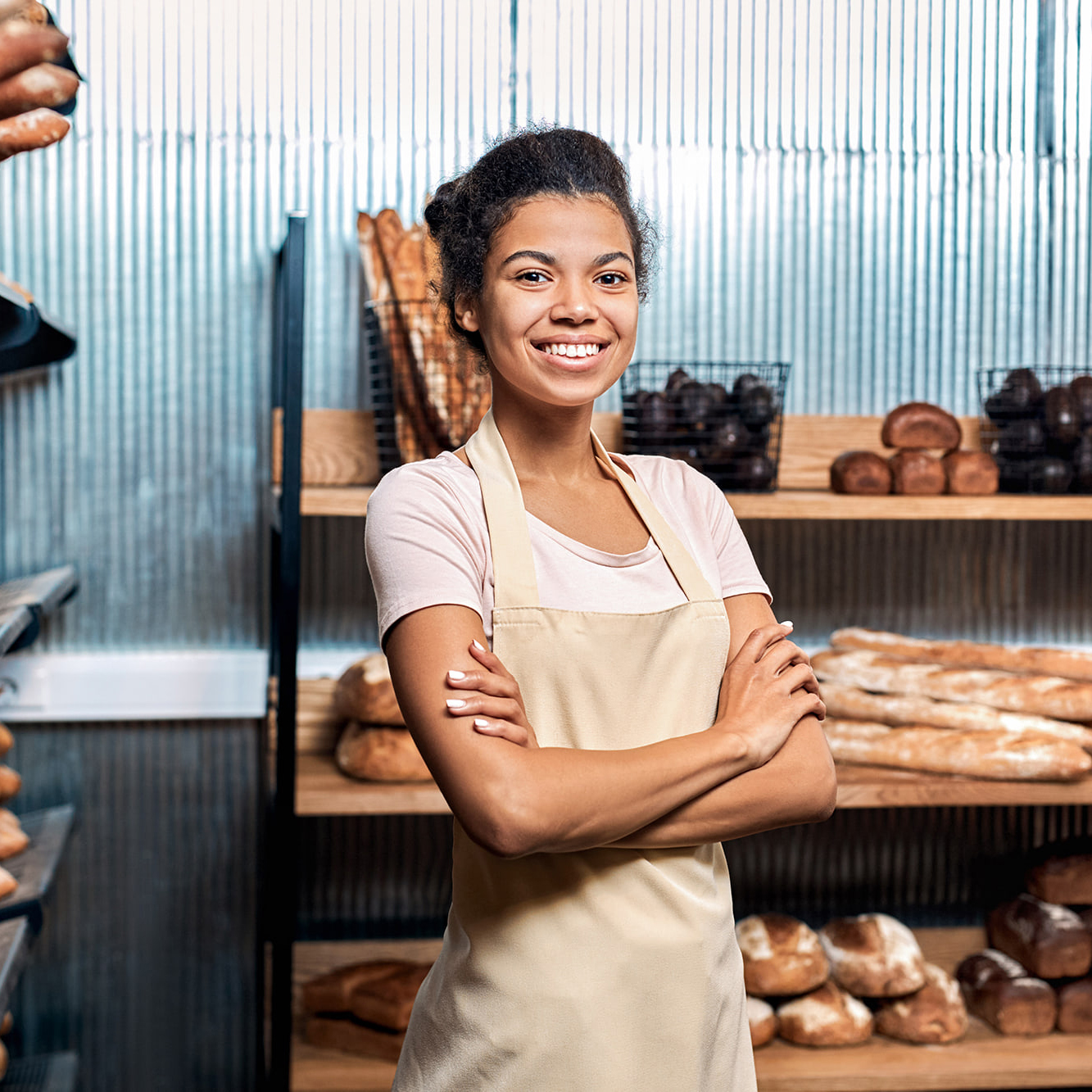 Bakery assistant in front of bread