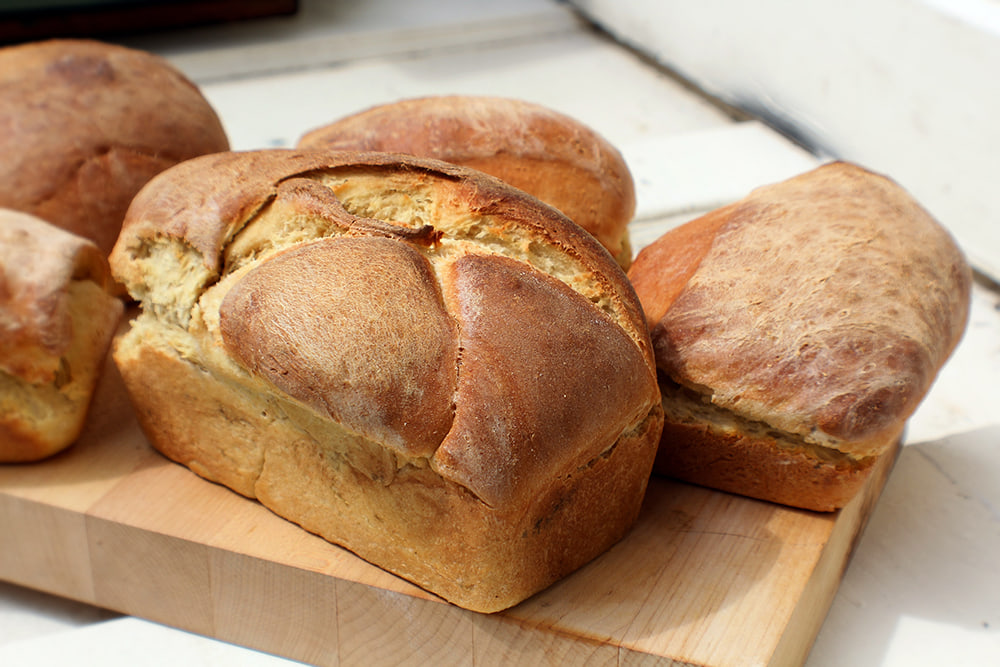 Bread loaves on chopping board