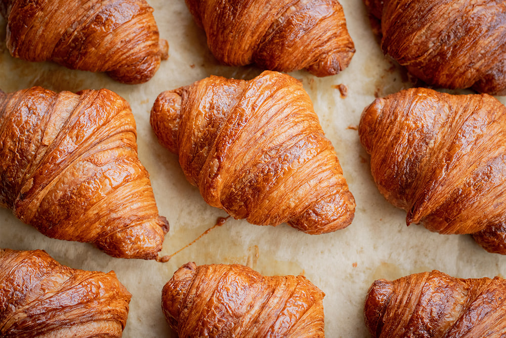 Freshly baked croissants on tray